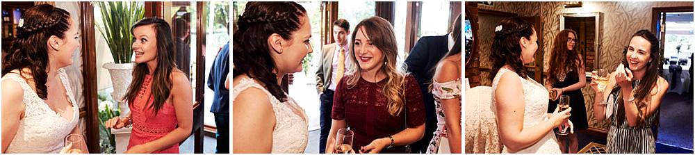 Candid photographs as the guests arrive for the fun of the evening reception at The Moat House in Acton Trussell by Documentary Wedding Photographer Stuart James