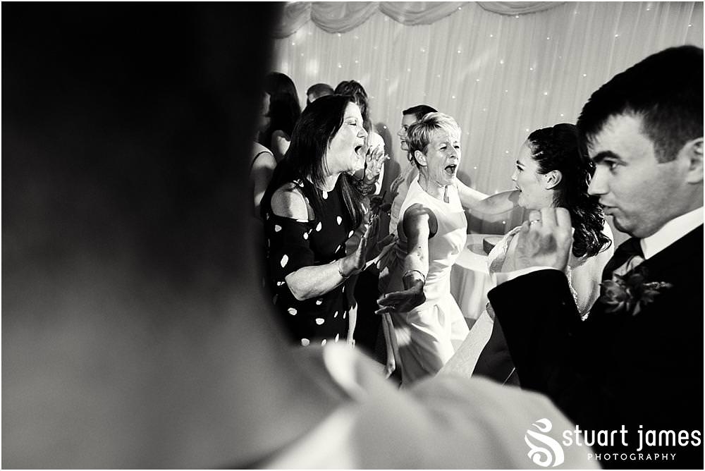 Capturing the fun of the evening reception as the dance floor fills for a fabulous night at The Moat House in Acton Trussell by Documentary Wedding Photographer Stuart James