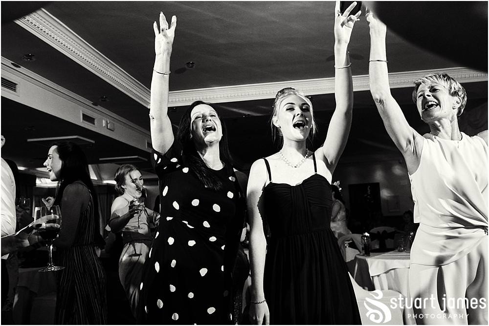 Capturing the fun of the evening reception as the dance floor fills for a fabulous night at The Moat House in Acton Trussell by Documentary Wedding Photographer Stuart James