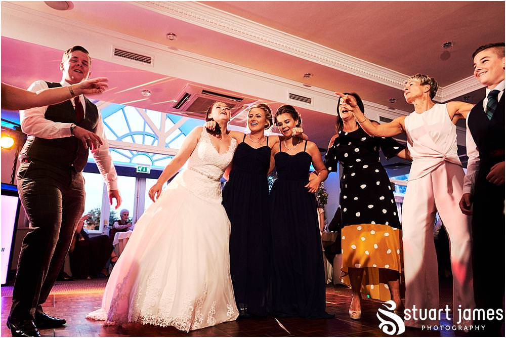 Capturing the fun of the evening reception as the dance floor fills for a fabulous night at The Moat House in Acton Trussell by Documentary Wedding Photographer Stuart James