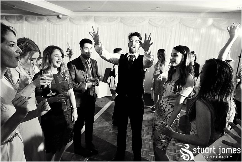 Capturing the fun of the evening reception as the dance floor fills for a fabulous night at The Moat House in Acton Trussell by Documentary Wedding Photographer Stuart James