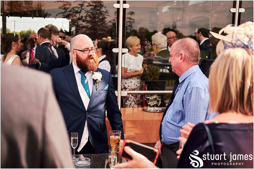 Creative candid photographs as the guests enjoy the drinks reception at The Crows Nest at Barton Marina by Documentary Wedding Photographer Stuart James