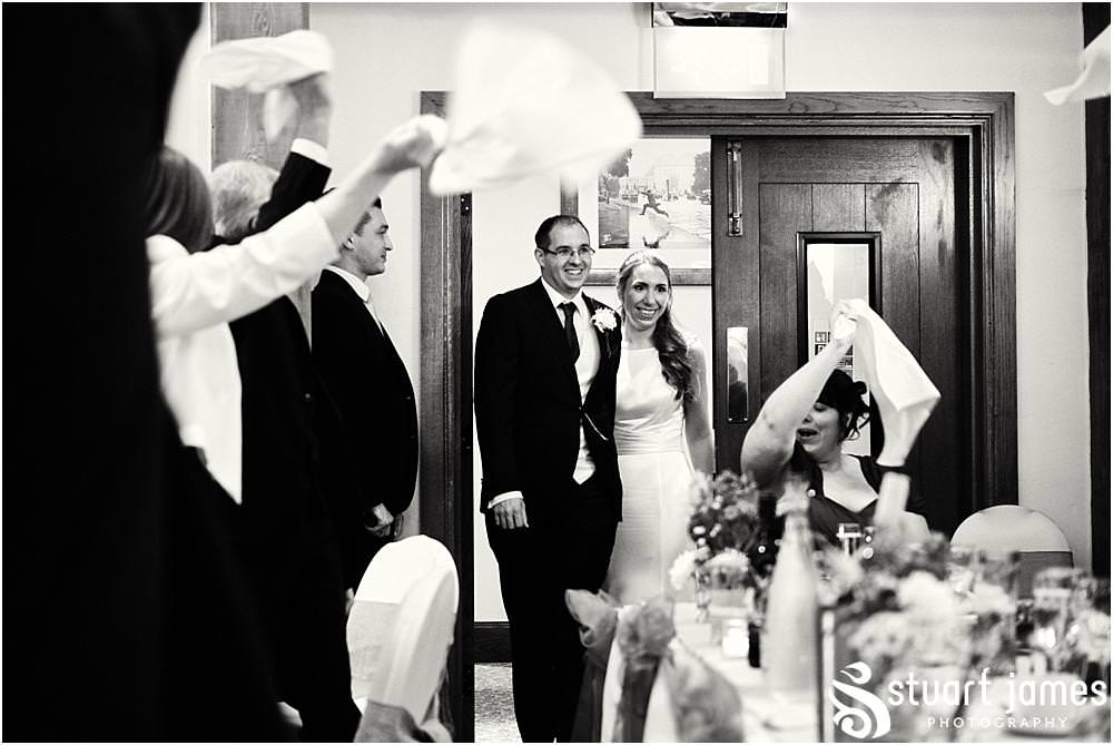 Creative candid photographs as the guests greet the bride and groom in to the wedding breakfast at The Crows Nest at Barton Marina by Documentary Wedding Photographer Stuart James