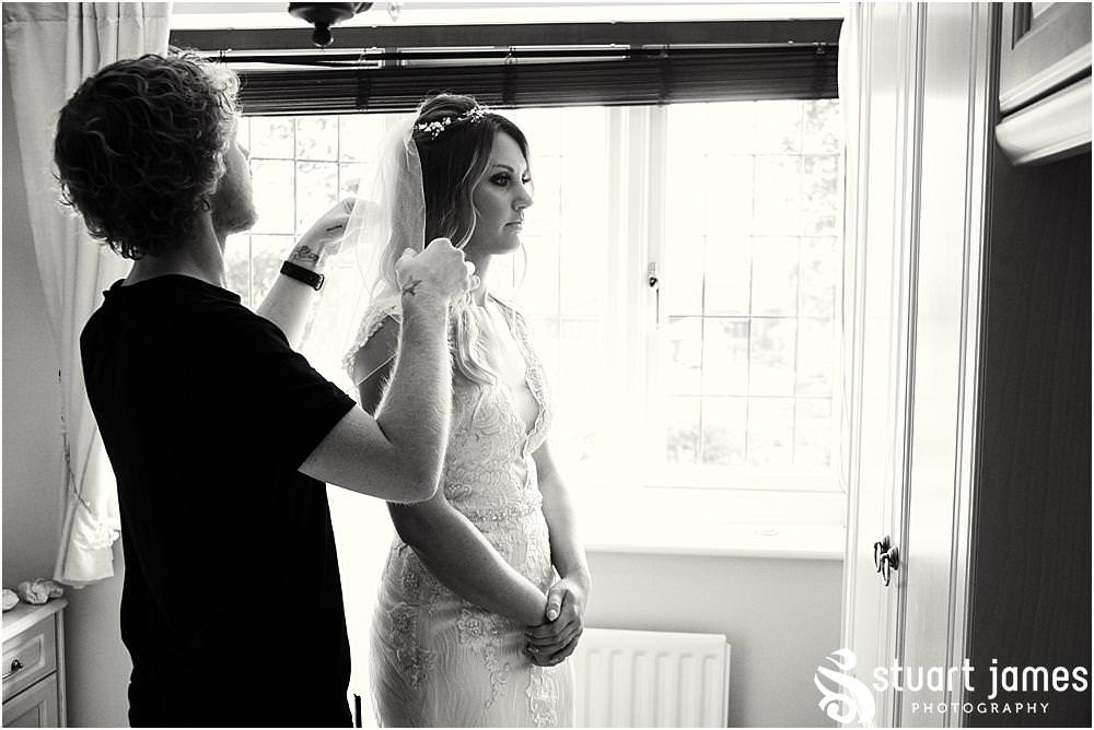 Capturing the dressing of the bride in the fabulous dress from The Dressing Rooms Halesowen for the wedding at Bishton Hall in Stafford by Documentary Wedding Photographer Stuart James