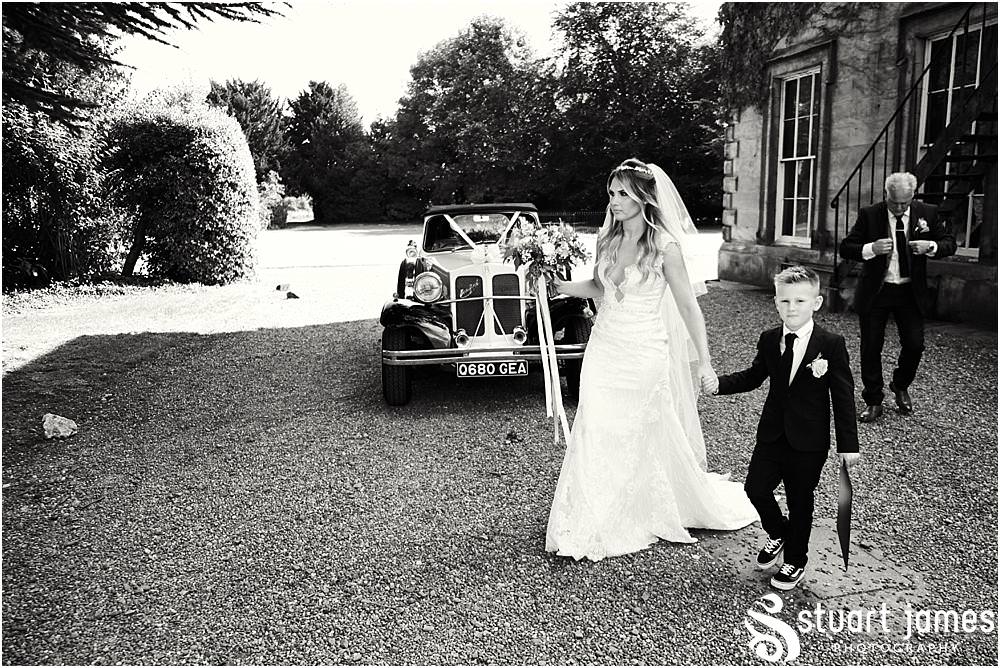 Arriving in style with His and Hers Wedding Cars at Bishton Hall in Stafford by Documentary Wedding Photographer Stuart James