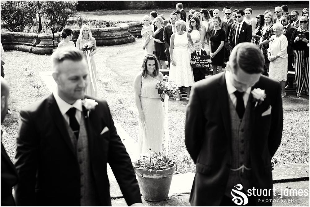 Documenting the moments as the bridal party process to the waiting groom at Bishton Hall in Stafford by Documentary Wedding Photographer Stuart James