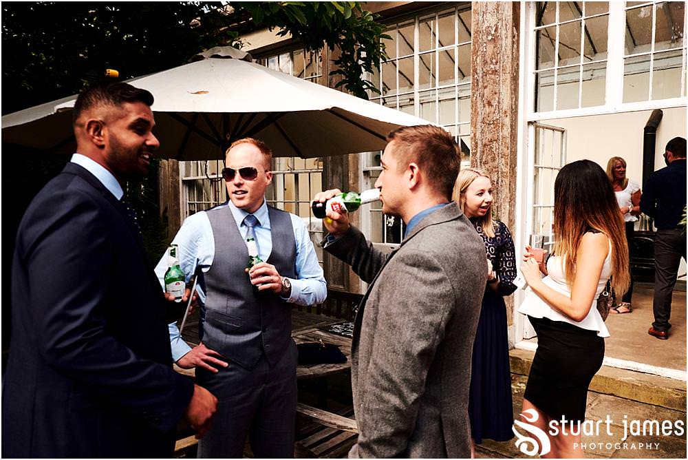 Creative candid photographs of the guests enjoying the fabulous afternoon drinks reception on the lawns at Bishton Hall in Stafford by Documentary Wedding Photographer Stuart James