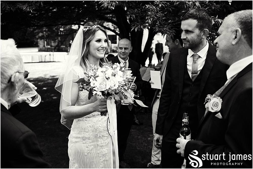 Creative candid photographs of the guests enjoying the fabulous afternoon drinks reception on the lawns at Bishton Hall in Stafford by Documentary Wedding Photographer Stuart James