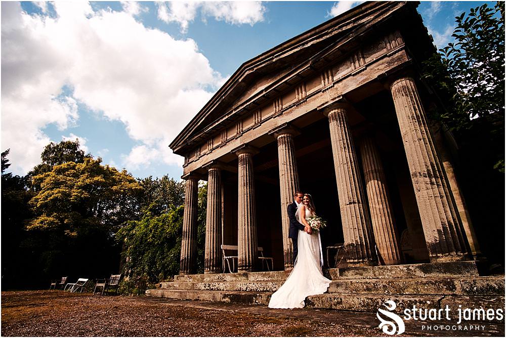 Creating timeless elegant portraits of the Bride and Groom with the Temple Backdrop at Bishton Hall in Stafford by Documentary Wedding Photographer Stuart James