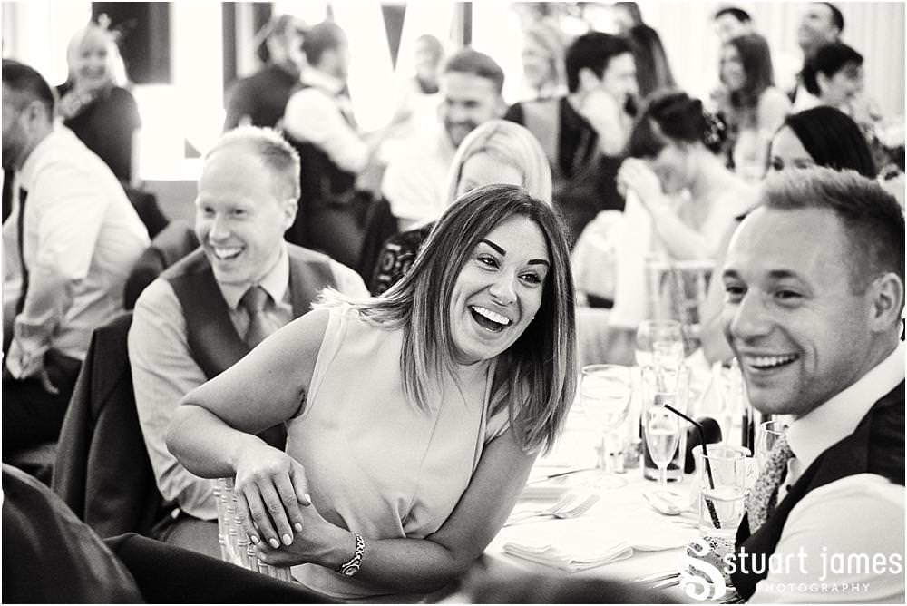 Creative candid photographs that capture the wonderful mood and reaction to the Father of the Brides speech at Bishton Hall in Stafford by Documentary Wedding Photographer Stuart James