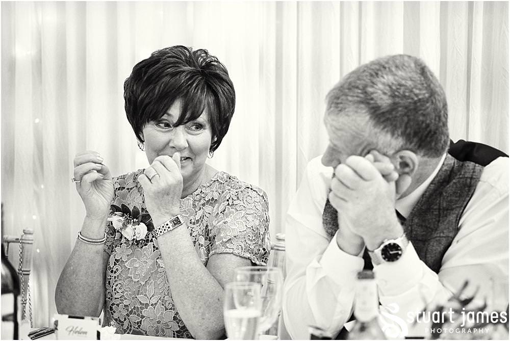 Creative candid photographs that capture the wonderful mood and reaction to the Father of the Brides speech at Bishton Hall in Stafford by Documentary Wedding Photographer Stuart James