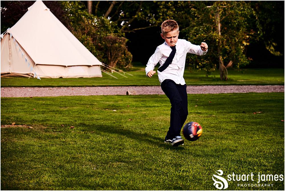 Capturing the guests enjoying the garden games during the wedding evening reception at Bishton Hall in Stafford by Documentary Wedding Photographer Stuart James