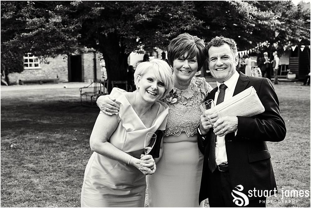 Unobtrusive photographs that capture the real moments of the wedding day as the guests relax and enjoy the evening reception at Bishton Hall in Stafford by Documentary Wedding Photographer Stuart James