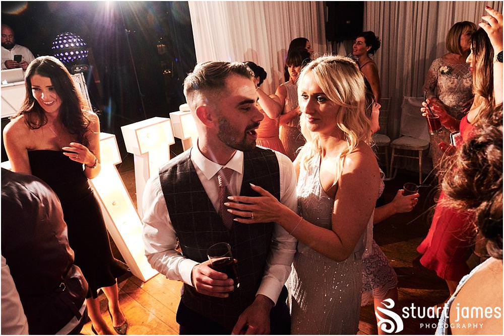 Creative photos that capture the life and soul of the wedding party as the guests have the most fabulous time on the dance floor at Bishton Hall in Stafford by Documentary Wedding Photographer Stuart James