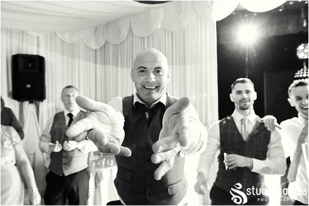 Creative photos that capture the life and soul of the wedding party as the guests have the most fabulous time on the dance floor at Bishton Hall in Stafford by Documentary Wedding Photographer Stuart James