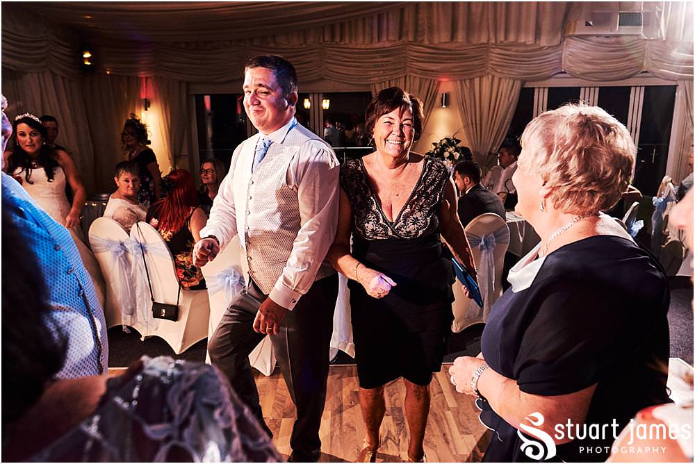 Candid photographs capturing the spirit and fun of the evening reception as the guests enjoy the fabulous wedding at Calderfields by Documentary Wedding Photographer Stuart James