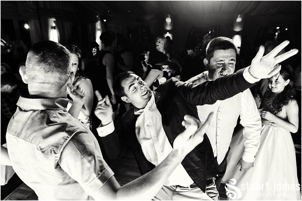 Photos that capture the guests having the most amazing time partying away on the dance floor at Calderfields by Documentary Wedding Photographer Stuart James
