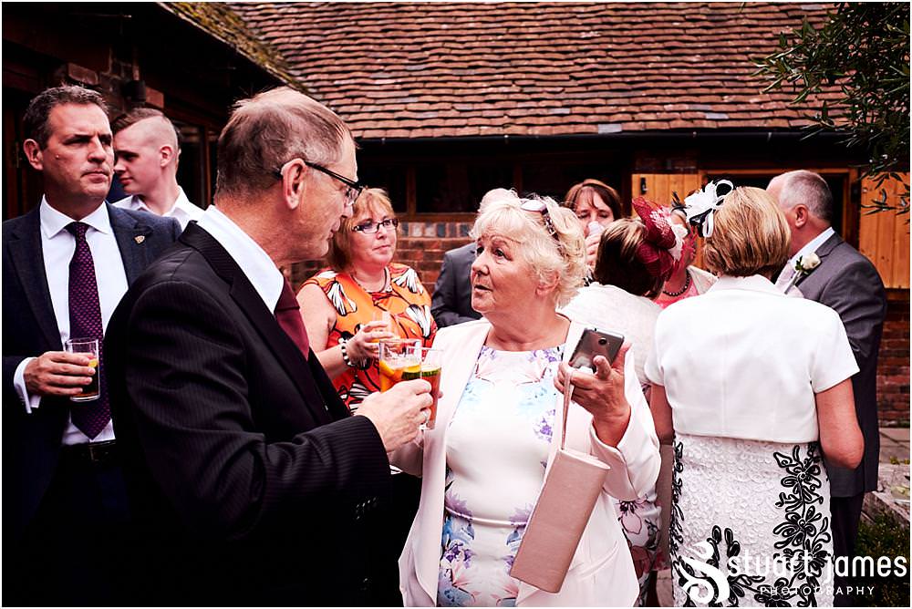 Creative candid photographs of the guests enjoying the wedding drinks reception at Packington Moor in Lichfield by Documentary Wedding Photographer Stuart James CREATIVE. EMOTIVE. STORYTELLING. Staffordshire Barn Wedding Photographs