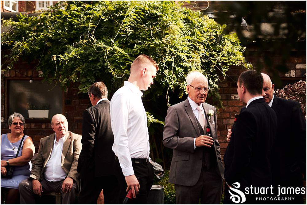 Relaxed candid photographs of the guests enjoying the drinks reception in the courtyard at Packington Moor in Lichfield by Documentary Wedding Photographer Stuart James CREATIVE. EMOTIVE. STORYTELLING. Staffordshire Barn Wedding Photographs