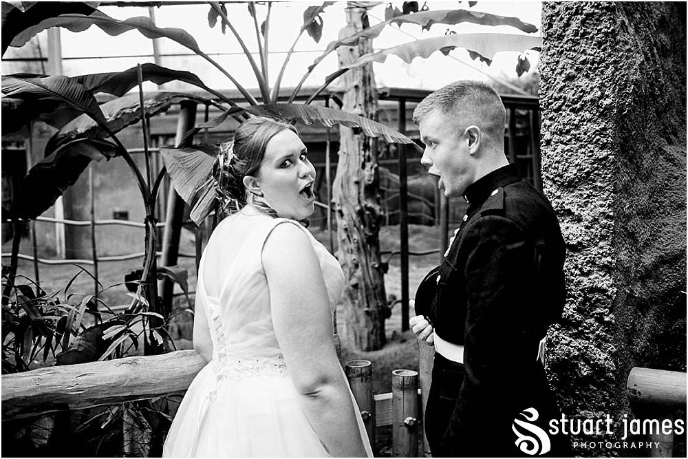 Creative photographs as the bride and groom and wedding guests enjoy an animal safari around Chester Zoo in Chester by Documentary Wedding Photographer Stuart James