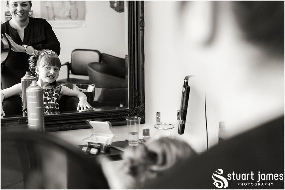 Creative documentary photography as the bride and bridesmaids have the finishing touches applied to the wedding hair ahead of the wedding at Oak Farm in Cannock by Oak Farm Wedding Photographer Stuart James