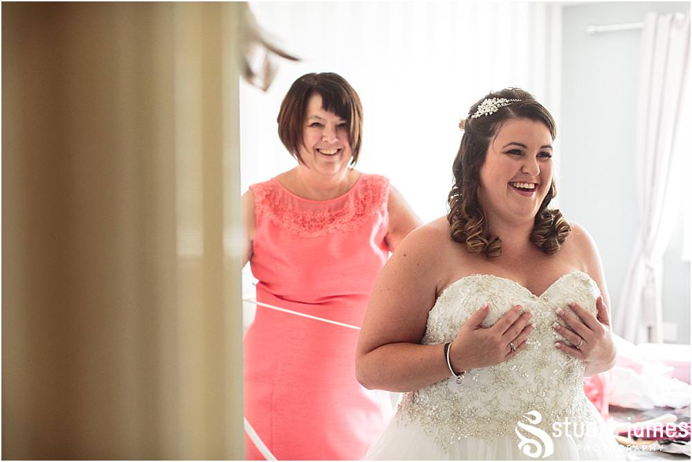 The moment it all comes together, as the bride dresses in her gorgeous gown for her wedding at Oak Farm in Cannock by Oak Farm Wedding Photographer Stuart James