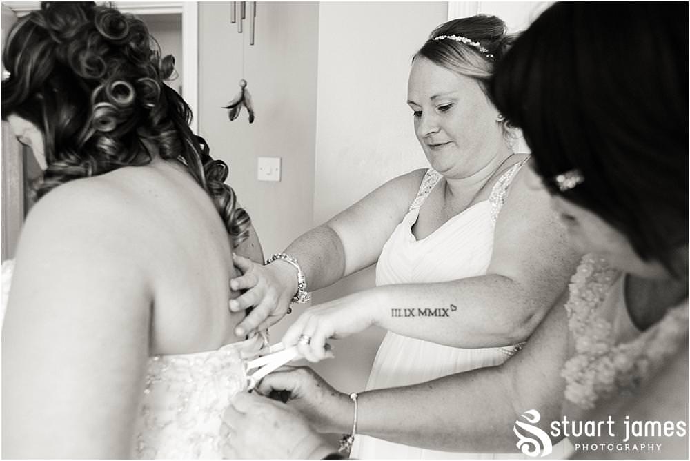 The moment it all comes together, as the bride dresses in her gorgeous gown for her wedding at Oak Farm in Cannock by Oak Farm Wedding Photographer Stuart James
