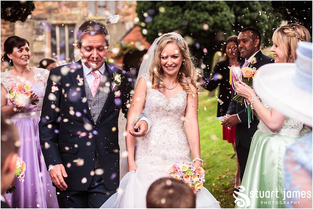 Creative fun candid photographs as the bride and groom leave Middleton Church and head to Moxhull Hall in Sutton Coldfield by Moxhull Hall Wedding Photographers Stuart James