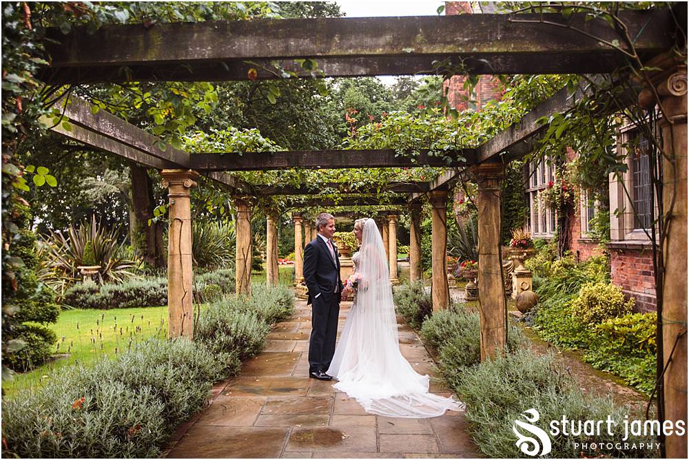 Creative natural portraits of the bride and groom in the stunning gardens at Moxhull Hall in Sutton Coldfield by Moxhull Hall Wedding Photographers Stuart James