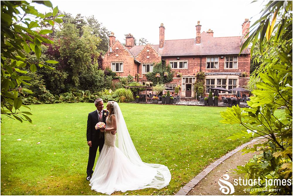 Creative natural portraits of the bride and groom in the stunning gardens at Moxhull Hall in Sutton Coldfield by Moxhull Hall Wedding Photographers Stuart James