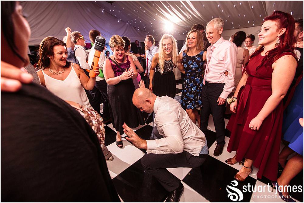 Right in the midst of the party, capturing the truly amazing time the bride and groom were having partying with their guests on the dance floor at Moxhull Hall in Sutton Coldfield by Moxhull Hall Wedding Photographers Stuart James