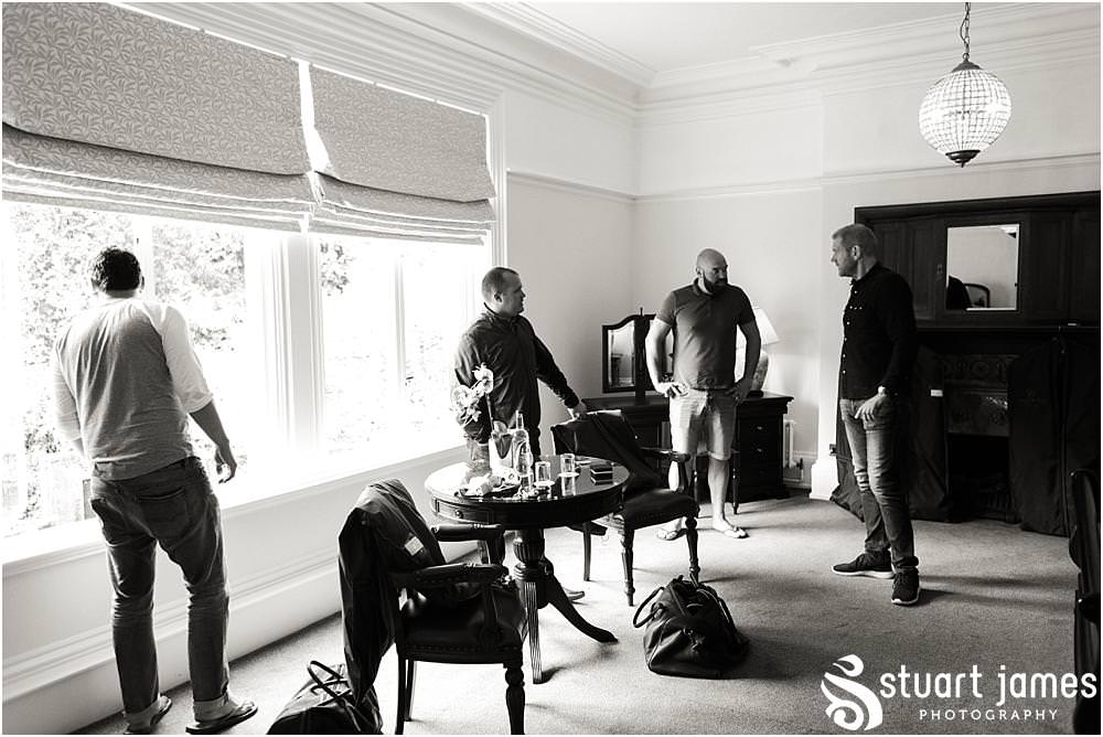Creative candid photographs capturing the groomsmen preparations for the wedding at Pendrell Hall with Pendrell Hall Wedding Photography by Stuart James