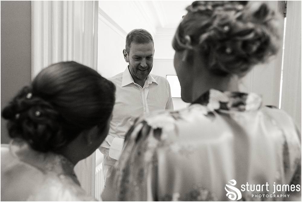 Photos of the emotion building for the groom as he opens his present from his bride at Pendrell Hall with Pendrell Hall Wedding Photography by Stuart James