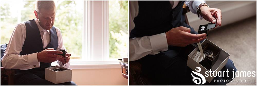 Photos of the emotion building for the groom as he opens his present from his bride at Pendrell Hall with Pendrell Hall Wedding Photography by Stuart James
