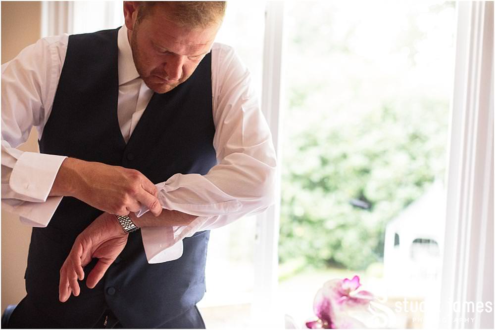 Photos of the emotion building for the groom as he opens his present from his bride at Pendrell Hall with Pendrell Hall Wedding Photography by Stuart James