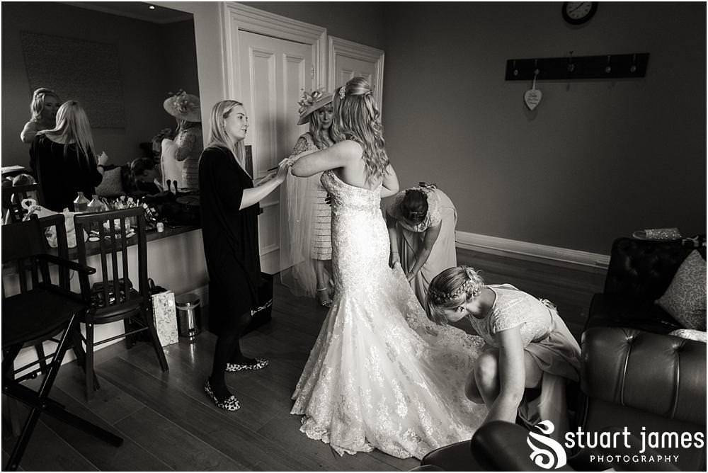 Capturing the finishing touches as our bride enters her stunning wedding gown at Pendrell Hall with Pendrell Hall Wedding Photography by Stuart James