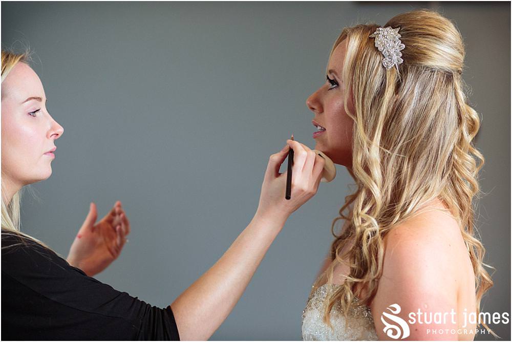 Capturing the finishing touches as our bride enters her stunning wedding gown at Pendrell Hall with Pendrell Hall Wedding Photography by Stuart James