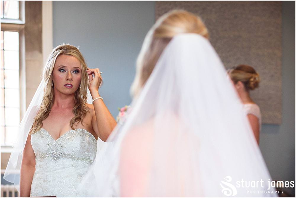 Capturing the finishing touches as our bride enters her stunning wedding gown at Pendrell Hall with Pendrell Hall Wedding Photography by Stuart James