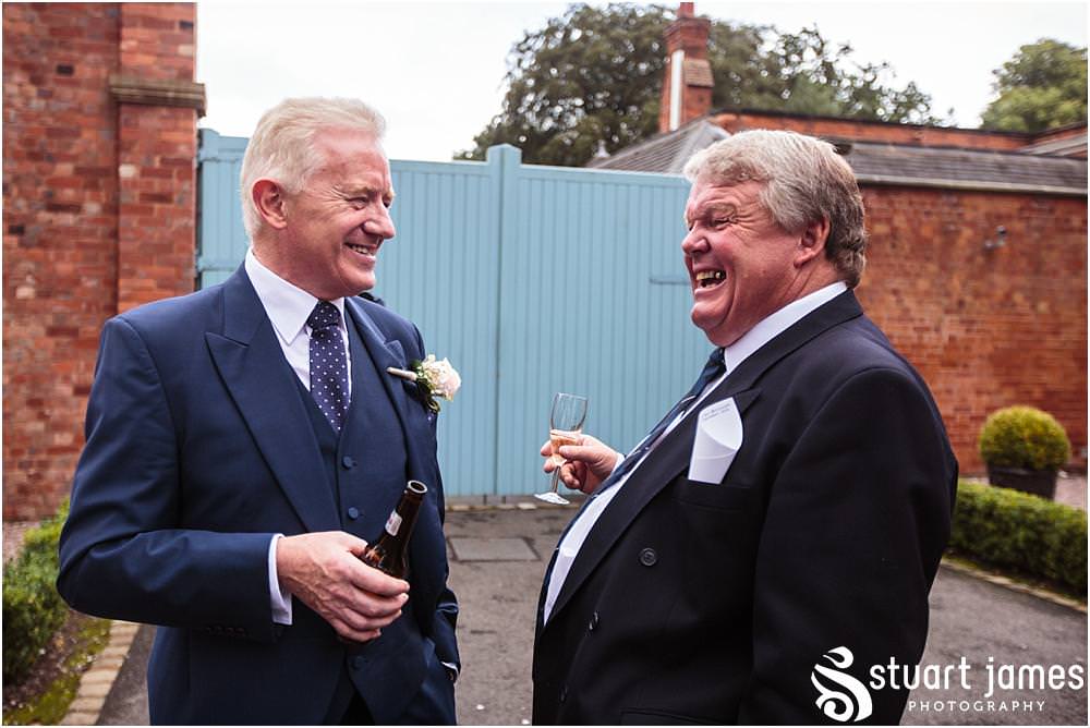 Creative candid photographs capturing the guests enjoying the drinks reception on the lawns at Pendrell Hall with Pendrell Hall Wedding Photography by Stuart James