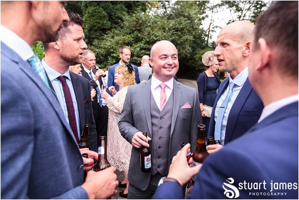 Creative candid photographs capturing the guests enjoying the drinks reception on the lawns at Pendrell Hall with Pendrell Hall Wedding Photography by Stuart James