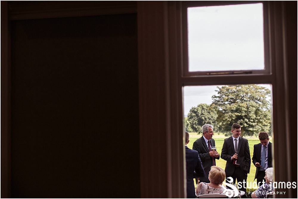 Creative candid photographs capturing the guests enjoying the drinks reception on the lawns at Pendrell Hall with Pendrell Hall Wedding Photography by Stuart James
