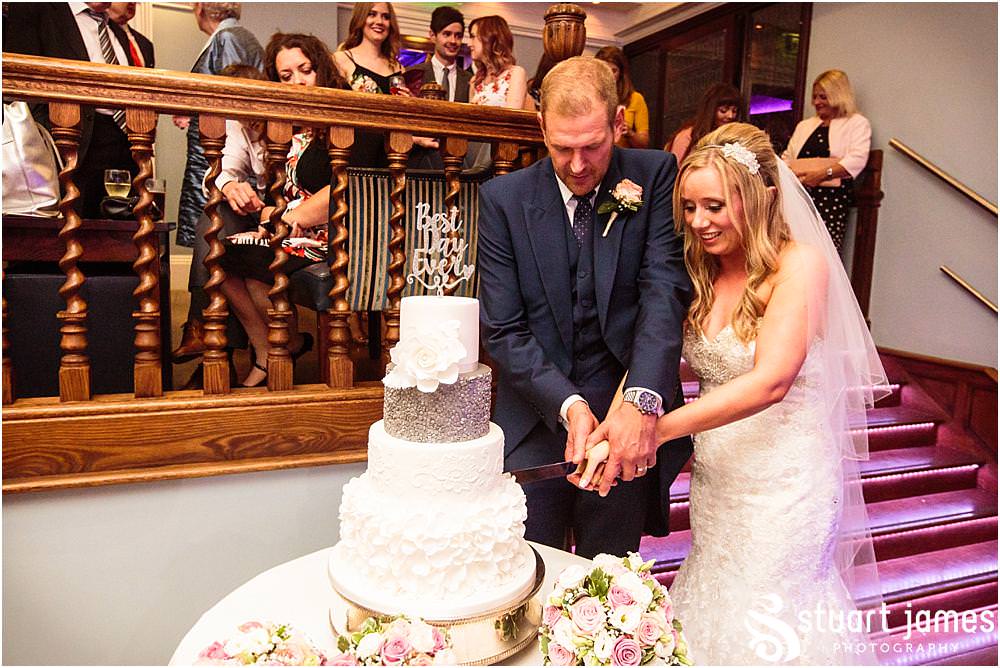 Cake cutting fun at Pendrell Hall with Pendrell Hall Wedding Photography by Stuart James