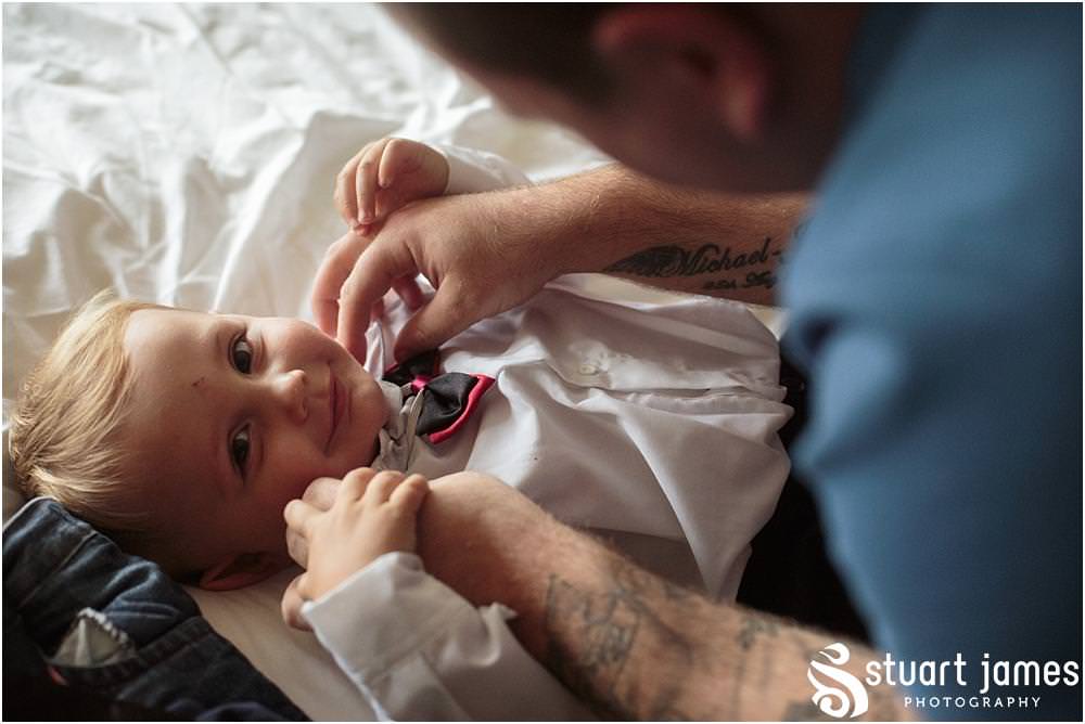 Capturing the relaxed preparations for the groom and groomsmen at home ahead of the wedding at All Saints Church in Bloxwich by Walsall Wedding Photographers Stuart James
