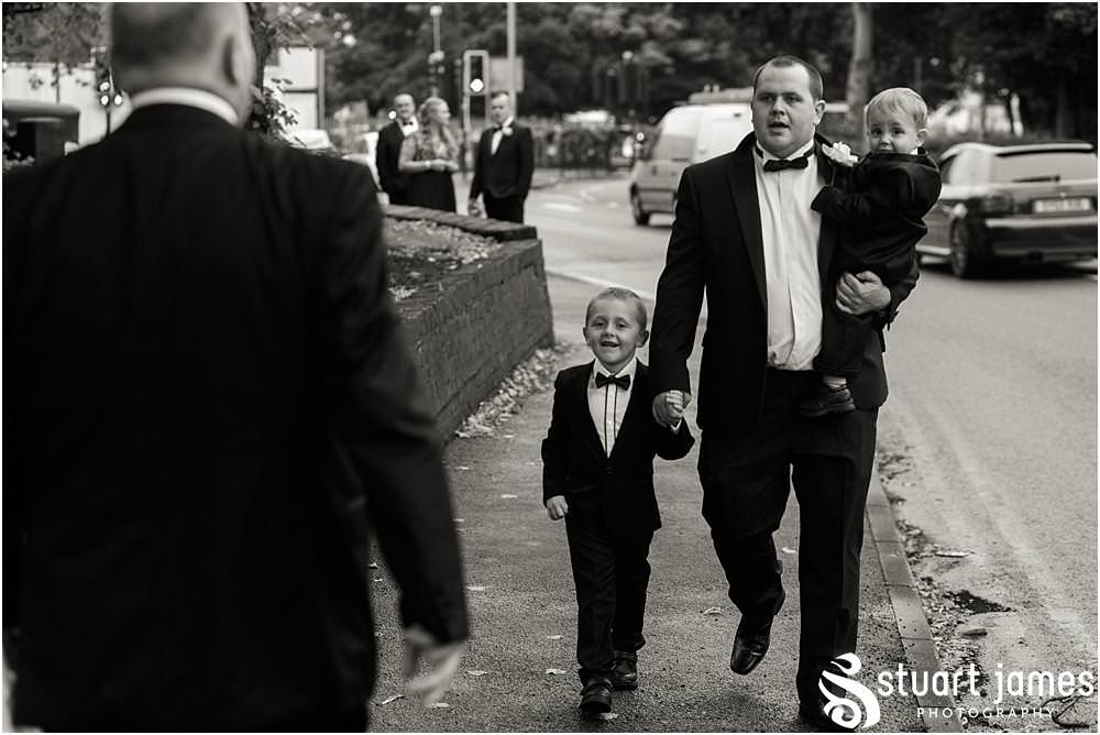 Creative photographs capturing the mood and excitement as the guests arrive for the wedding ceremony at All Saints Church in Bloxwich by Walsall Wedding Photographers Stuart James