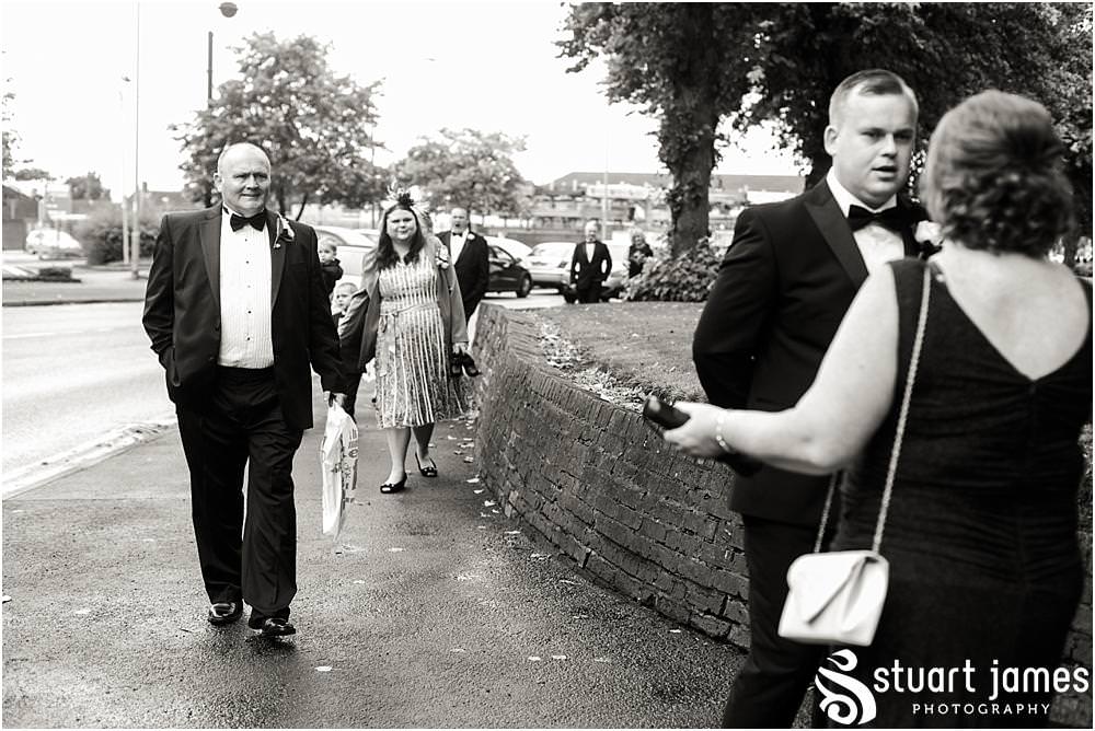 Creative photographs capturing the mood and excitement as the guests arrive for the wedding ceremony at All Saints Church in Bloxwich by Walsall Wedding Photographers Stuart James