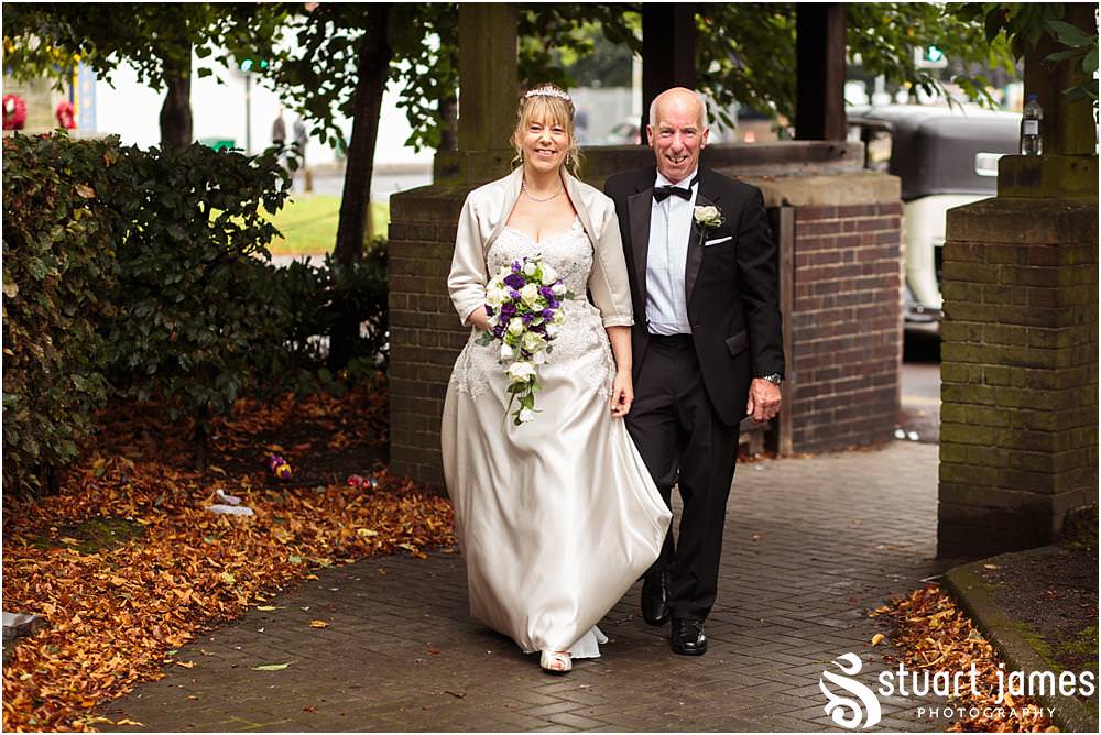 Capturing the excitement as the bride arrives for the wedding ceremony at All Saints Church in Bloxwich by Walsall Wedding Photographers Stuart James