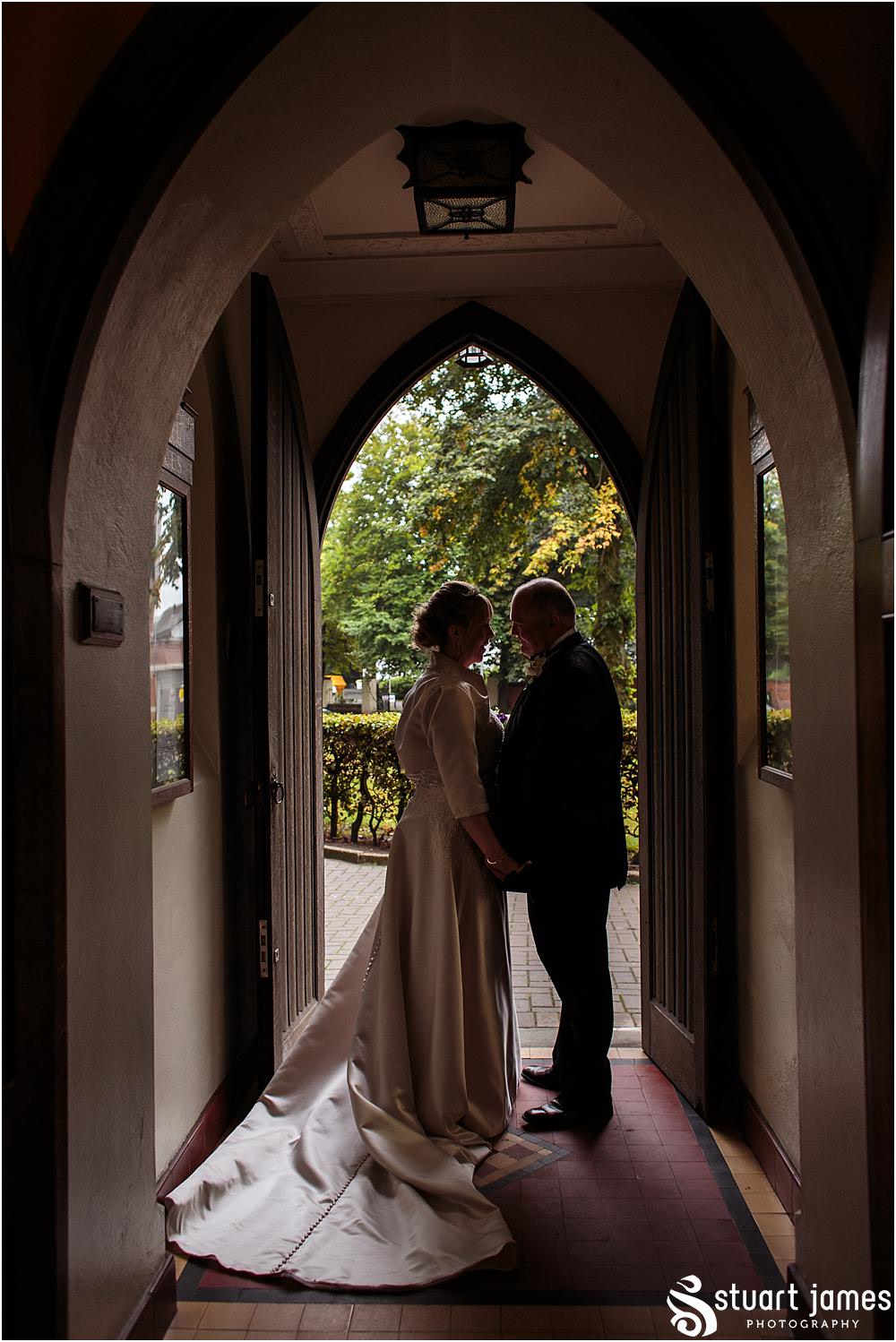 Capturing the excitement as the new Mr & Mrs lead their guests from the church at All Saints Church in Bloxwich by Walsall Wedding Photographers Stuart James