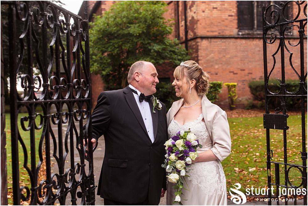 Capturing the excitement as the new Mr & Mrs lead their guests from the church at All Saints Church in Bloxwich by Walsall Wedding Photographers Stuart James