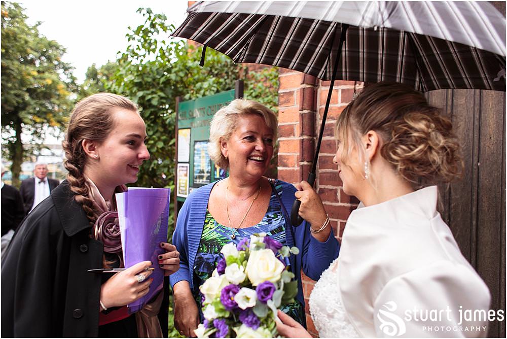 Capturing the excitement as the new Mr & Mrs lead their guests from the church at All Saints Church in Bloxwich by Walsall Wedding Photographers Stuart James