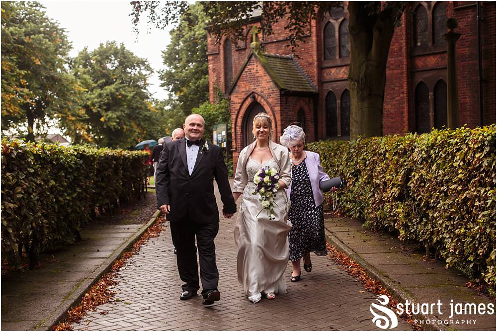 Capturing the excitement as the new Mr & Mrs lead their guests from the church at All Saints Church in Bloxwich by Walsall Wedding Photographers Stuart James